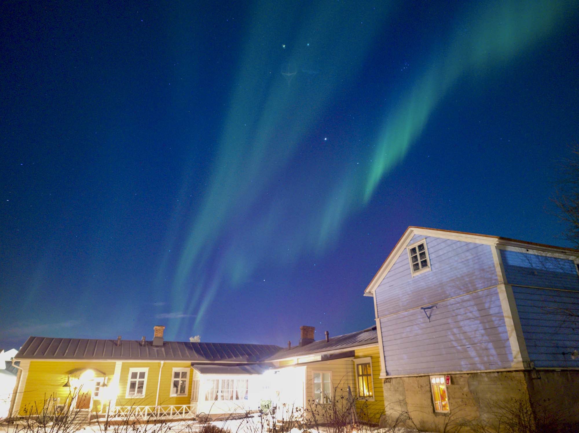 Northern Lights over historic buildings